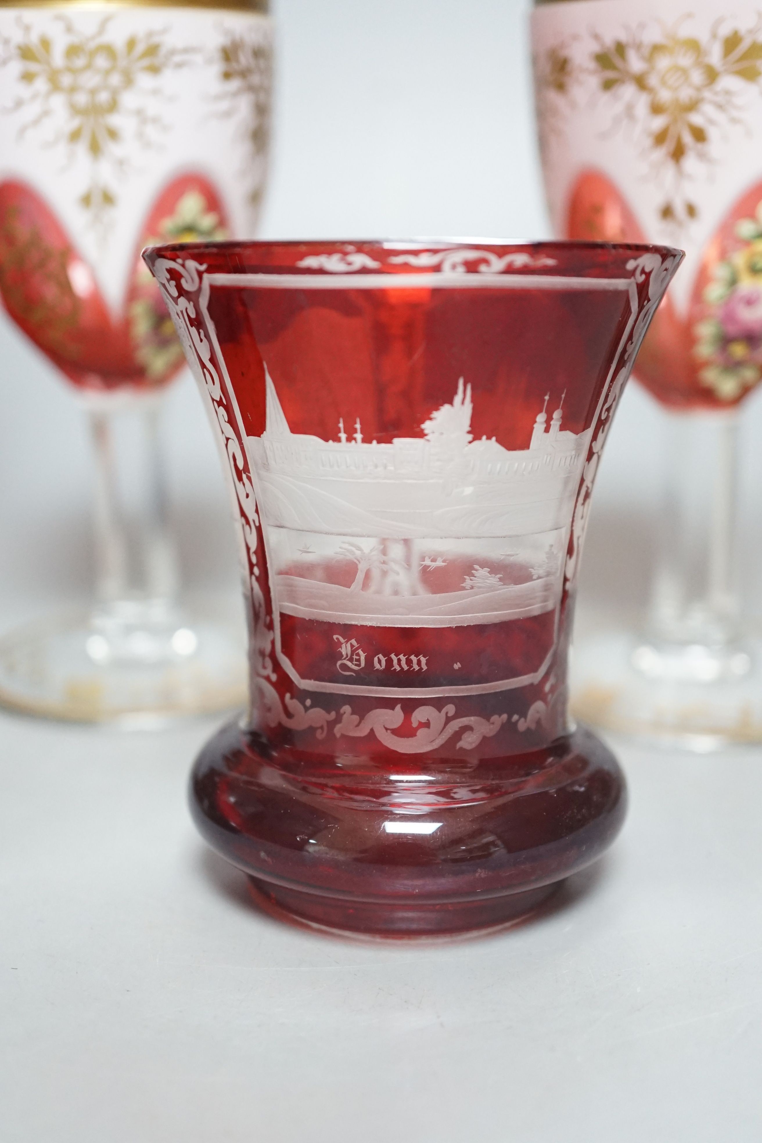 A pair of 19th century Bohemian ruby overlaid wine glasses, possibly Moser and other bohemian ruby glasswares